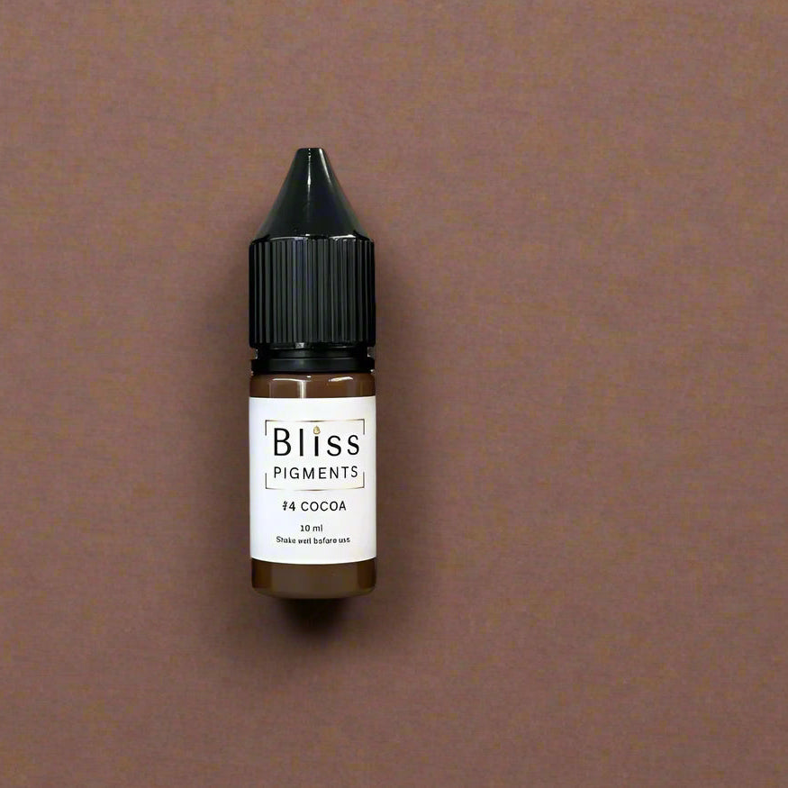 Set of six bottles of Bliss Pigments on a beige background