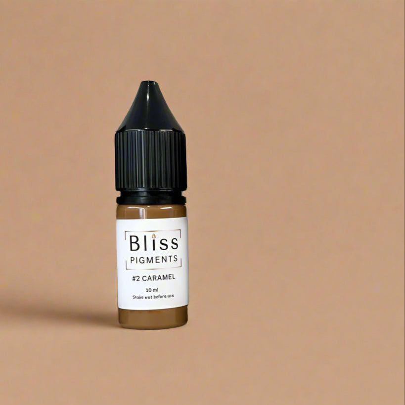 Bottle of Bliss Pigments #2 Caramel on a beige background