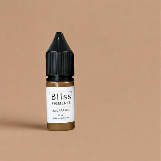 Bottle of Bliss Pigments #2 Caramel on a beige background